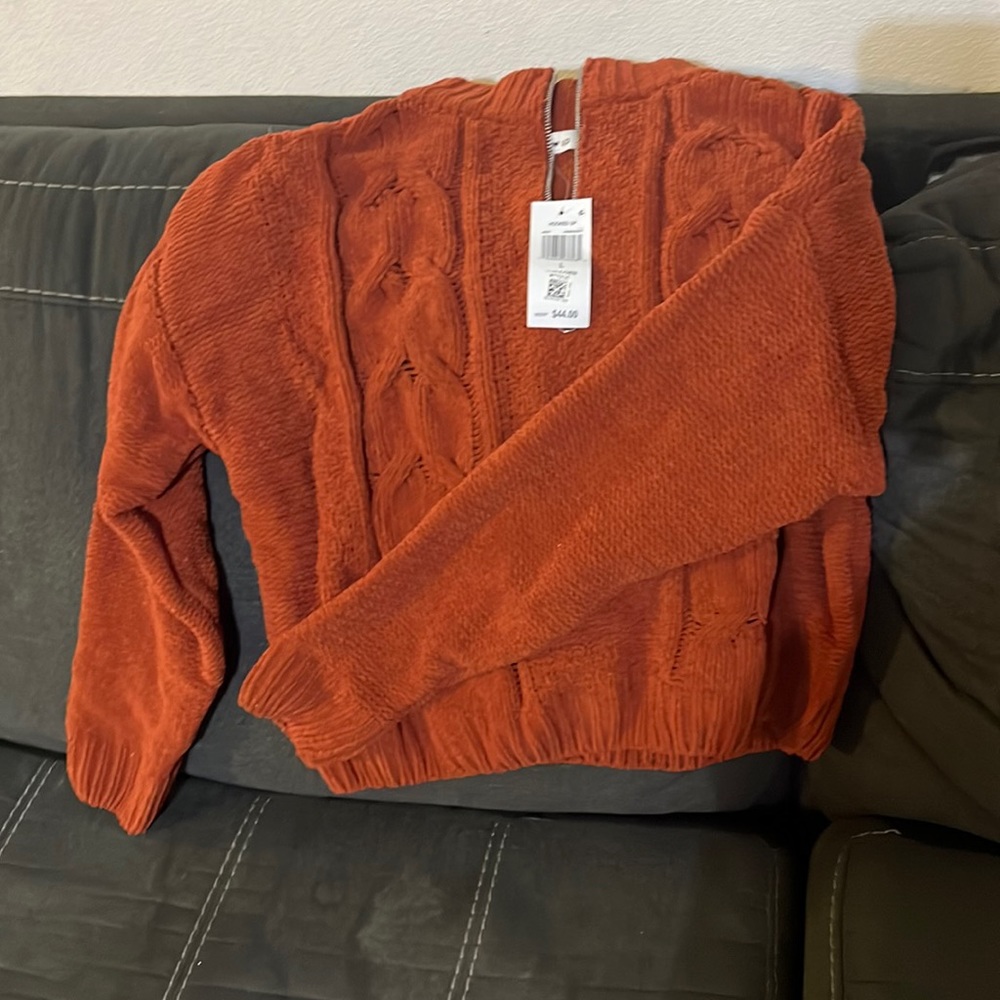 Brand new burnt orange soft woman’s sweater.